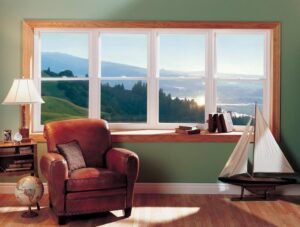 : Interior bow window with white trim, wood framing, and a scenic mountain view.